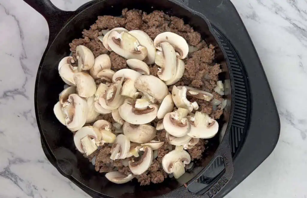 Add the sliced mushrooms.