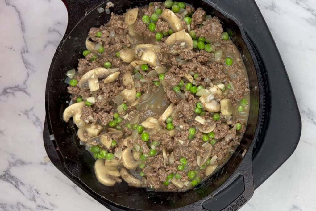 Fold in the frozen peas.