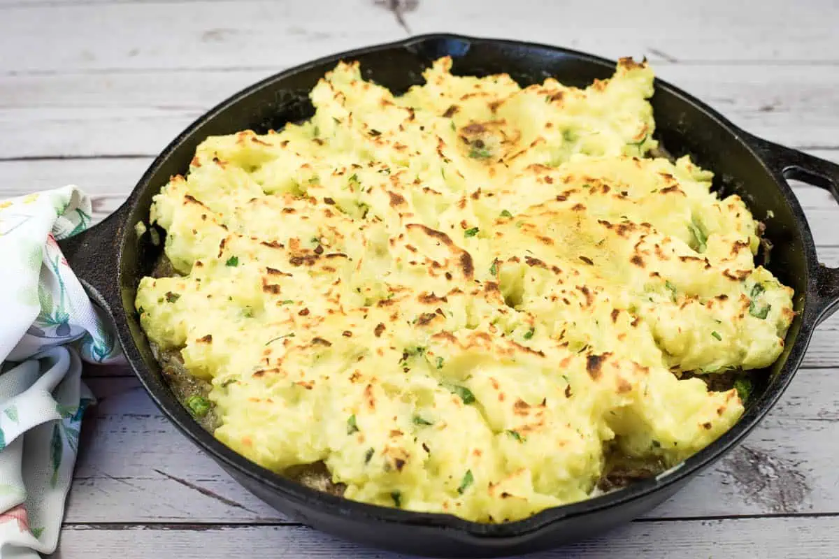 A Skillet Stroganoff Pie with a small missing portion.