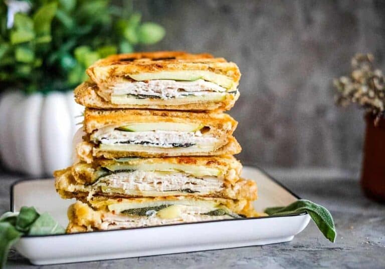 Turkey & apple panini stacked on a plate.