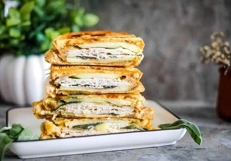 Turkey & apple panini stacked on a plate.