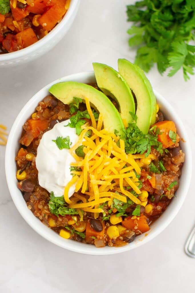 Top-down shot of a white bowl of Sweet Potato Chili with Quinoa.