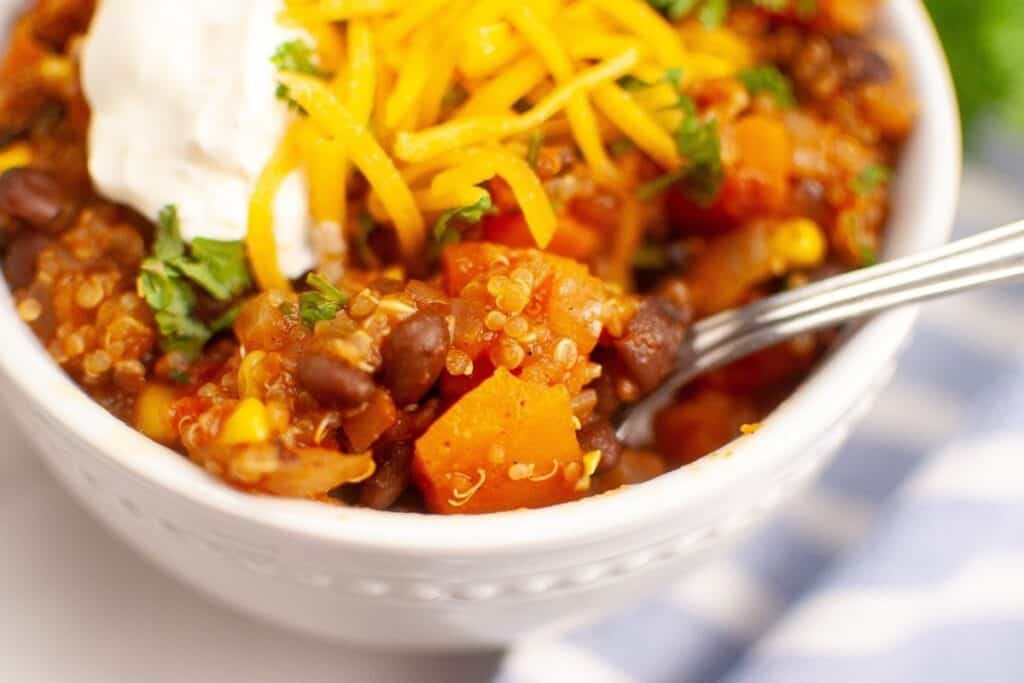 A spoonful of Sweet Potato Chili with Quinoa in a bowl.