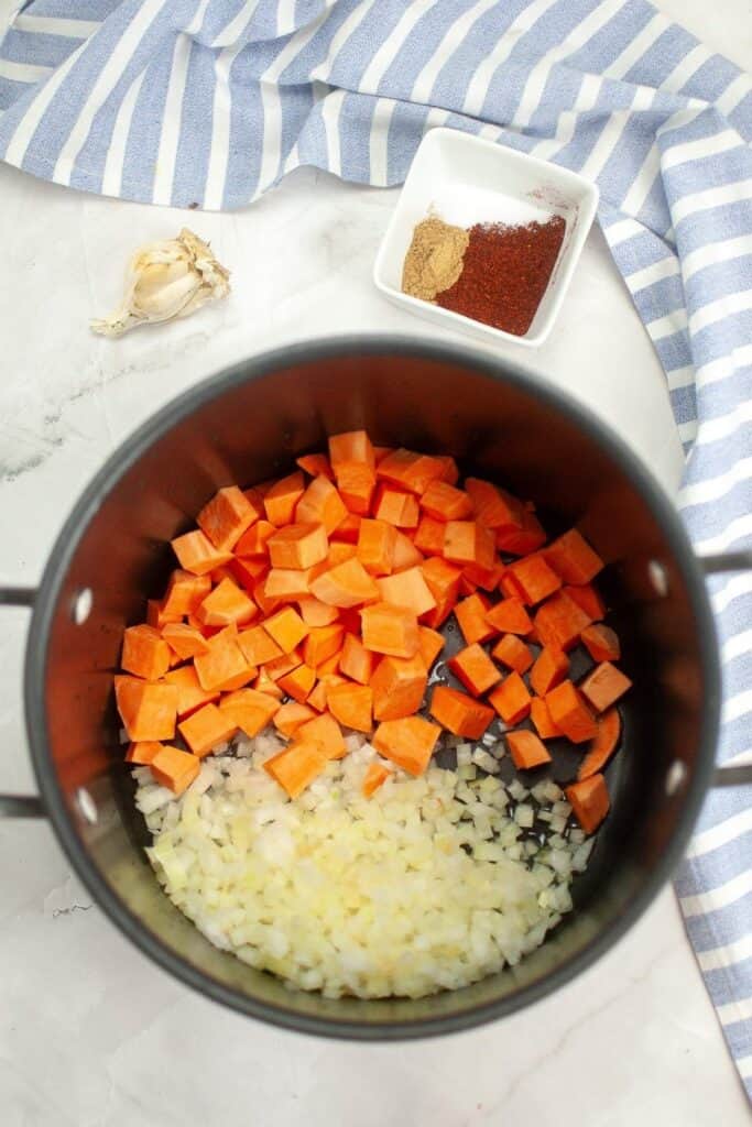 Add the diced sweet potato and chopped onion to the pot.