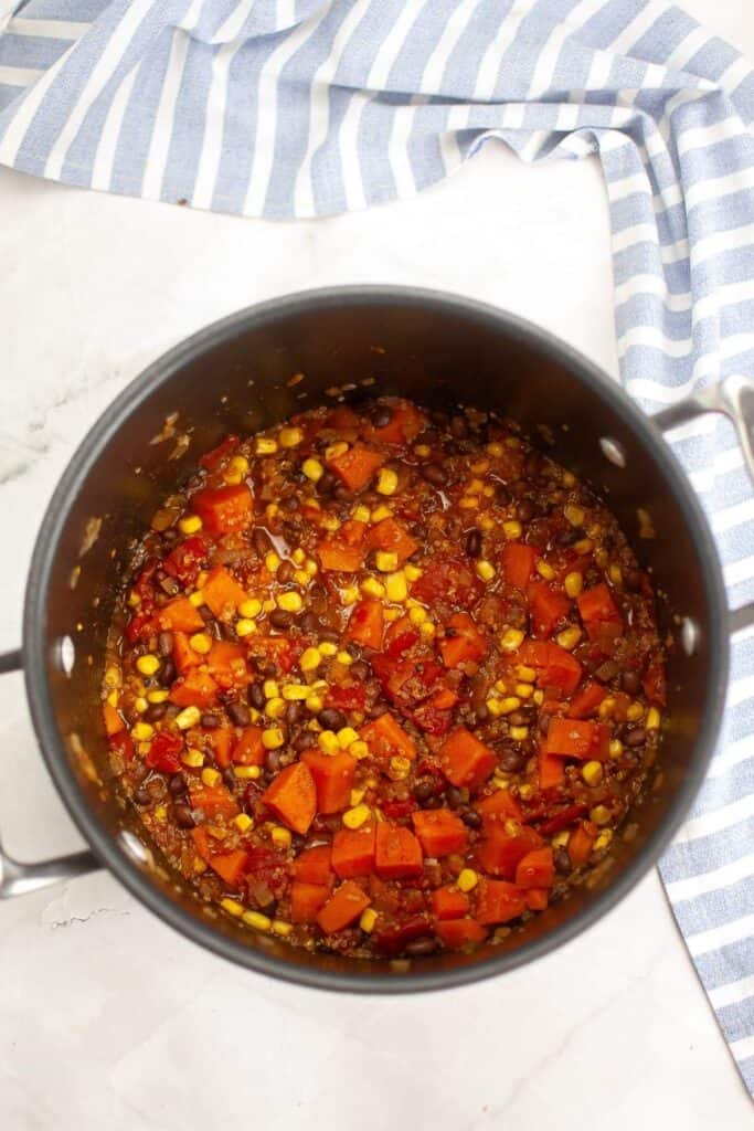 Stir in the corn niblets and let the chili simmer.