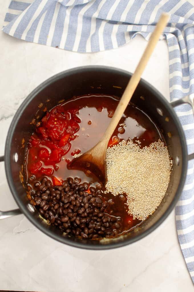 Add the vegetable broth, fire-roasted tomatoes, black beans, and quinoa.
