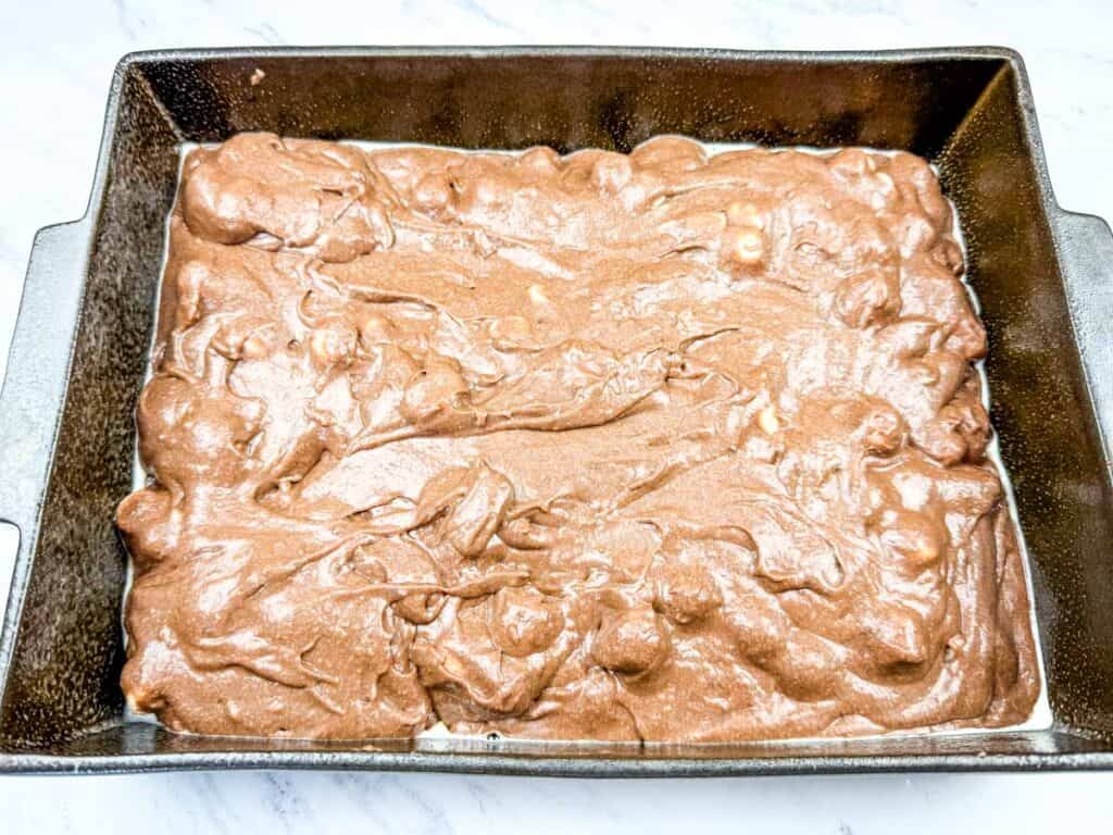 Pour the batter into the prepared baking pan.
