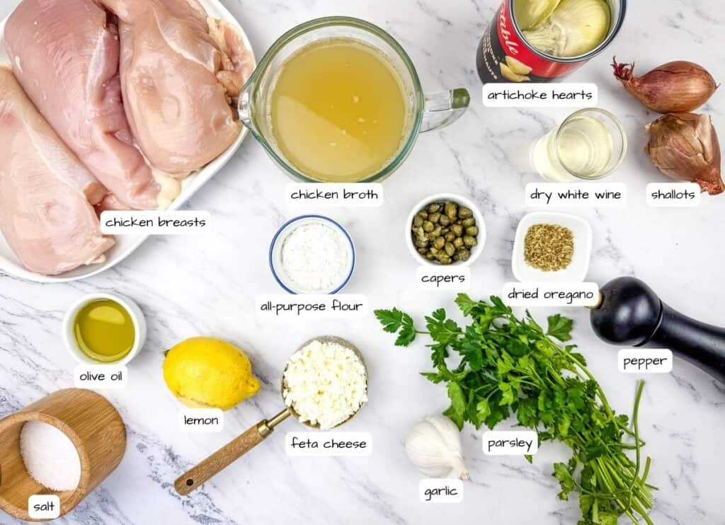 Ingredients on a marble surface include raw chicken breasts, chicken broth, artichoke hearts, dry white wine, shallots, capers, dried oregano, olive oil, lemon, feta cheese, parsley, garlic, salt, and pepper.