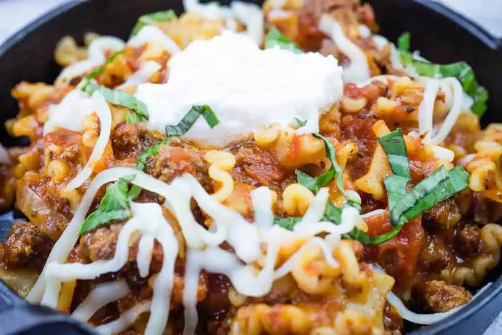 Skillet lasagna served in a black bowl.
