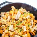 A serving of Sweet Potato Hash with Pulled Pork in black skillet.