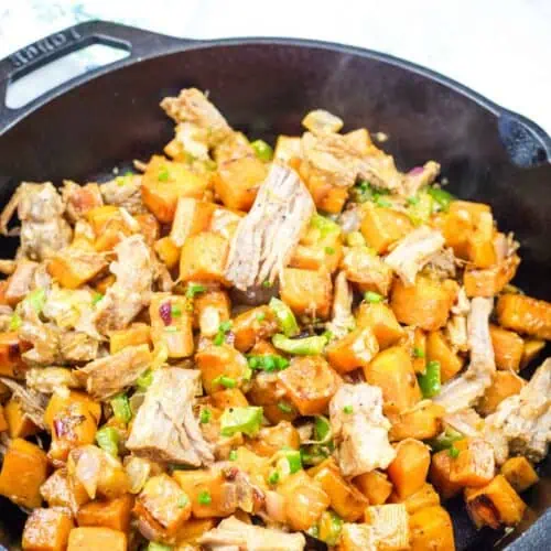 A serving of Sweet Potato Hash with Pulled Pork in black skillet.