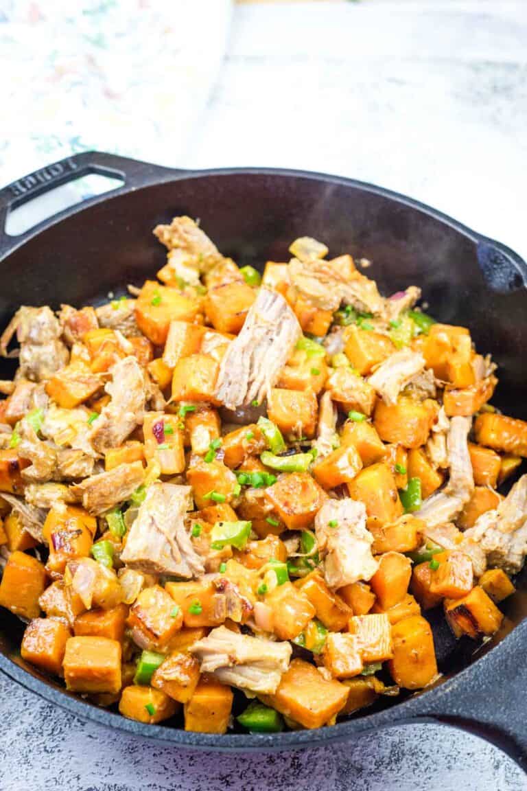 A serving of Sweet Potato Hash with Pulled Pork in black skillet.
