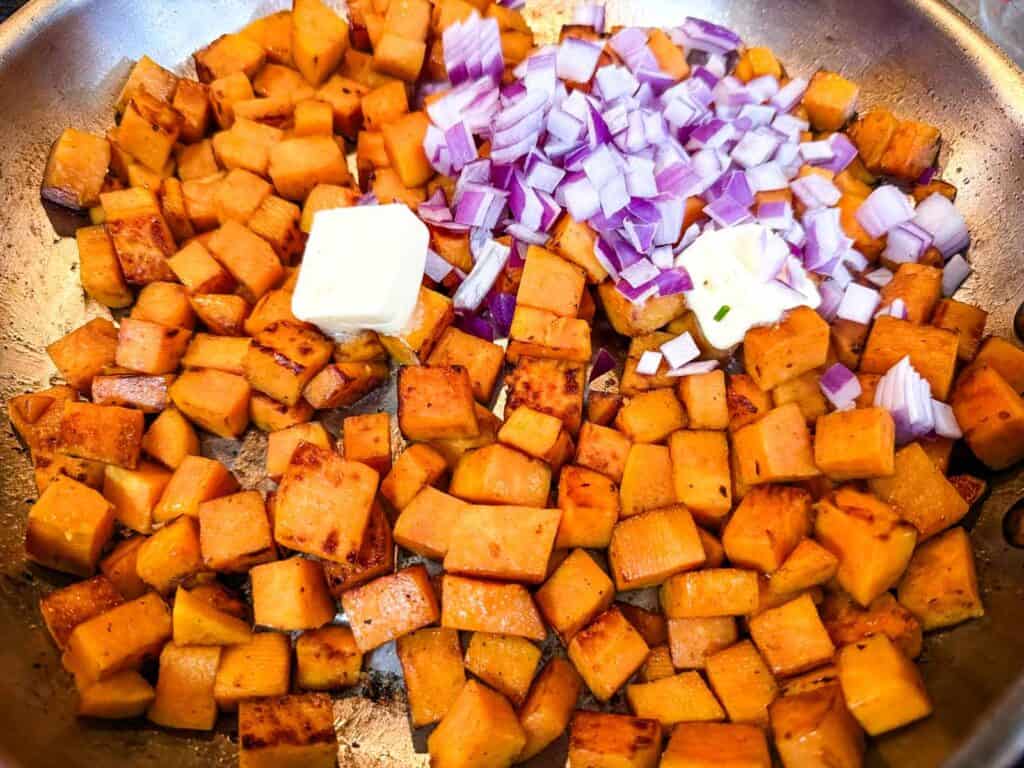Add the butter, chopped onion, and minced garlic.