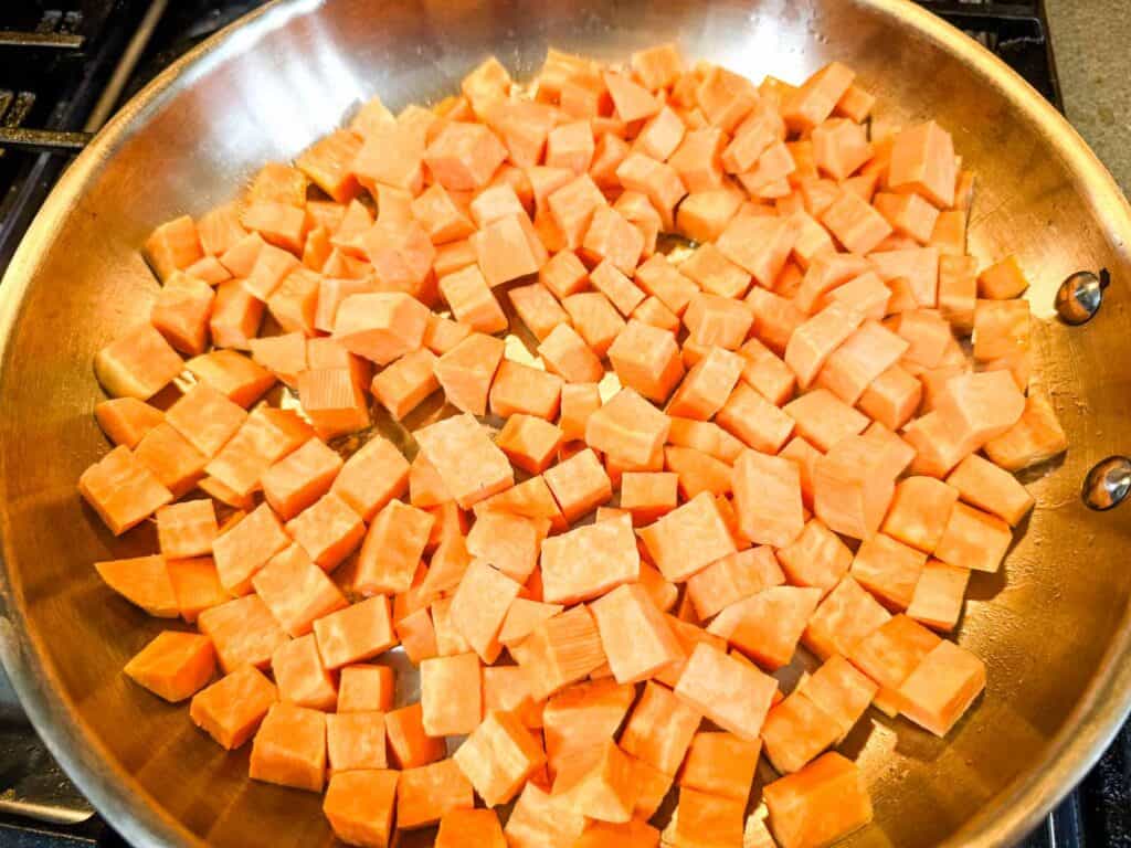 Cubed sweet potatoes in a pan.