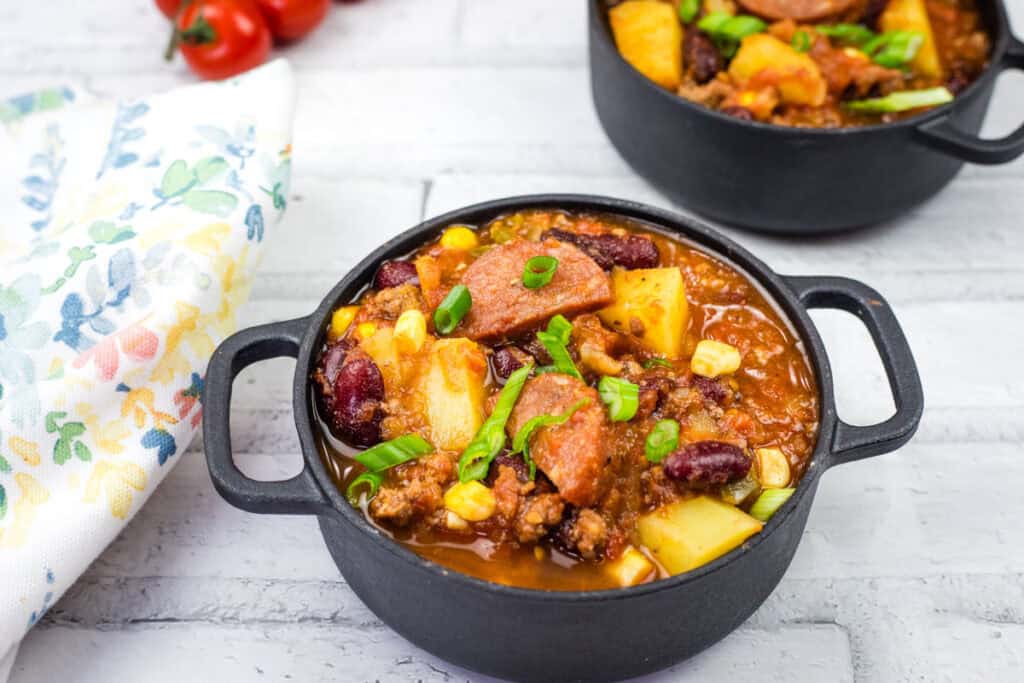 Two black skillet filled with Texas cowboy stew.