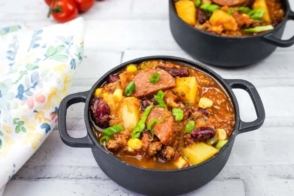 Two black skillet filled with Texas cowboy stew.