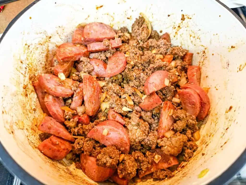 Add the smoked sausage, spices, and veggies.