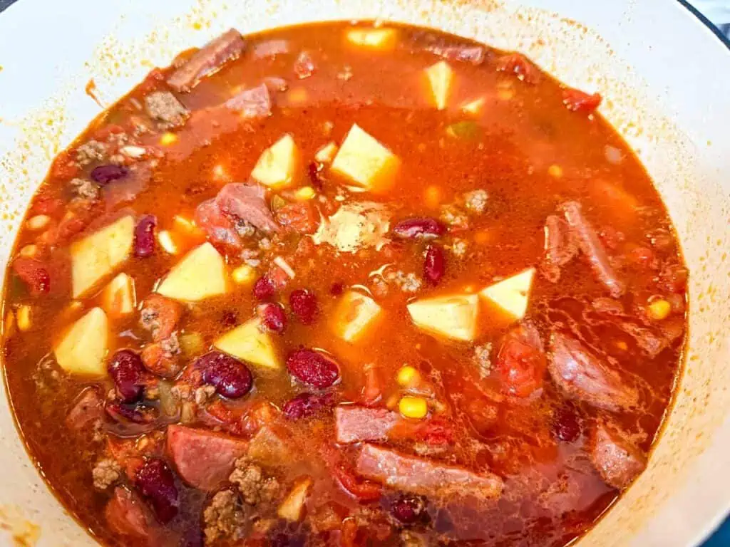 Add the potatoes, kidney beans, corn, and tomatoes.