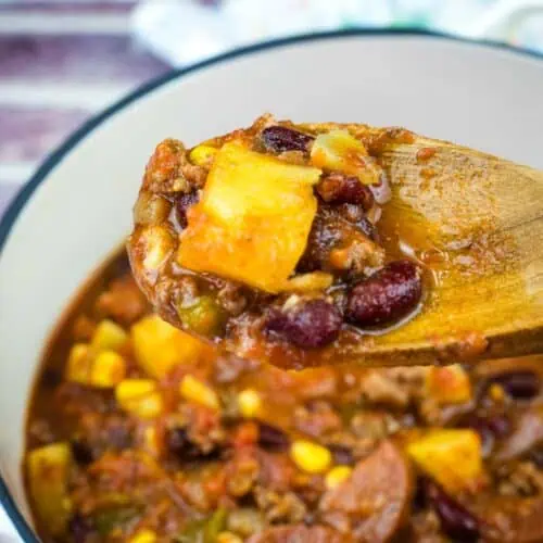 A wooden spoon with a Texas Cowboy Stew from a casserole.