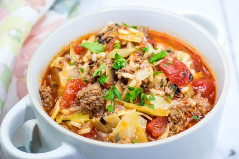 A delicious cabbage roll soup in a white bowl.