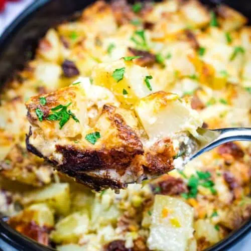 A spoon with a Mississippi Mud Potatoes from the casserole dish.