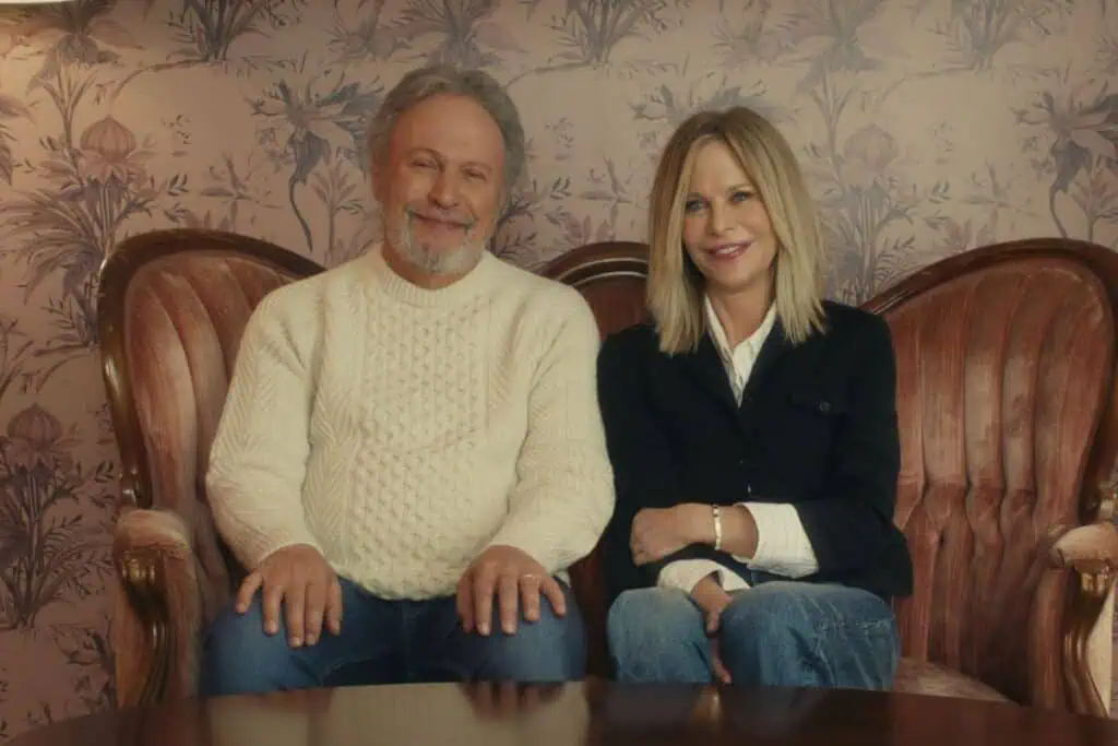 Billy Crystal and Meg Ryan sitting on a couch.