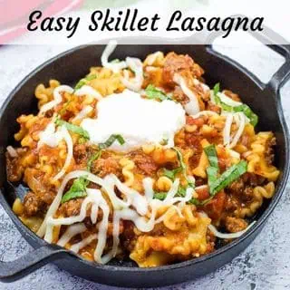 A serving of skillet lasagna in a black bowl.