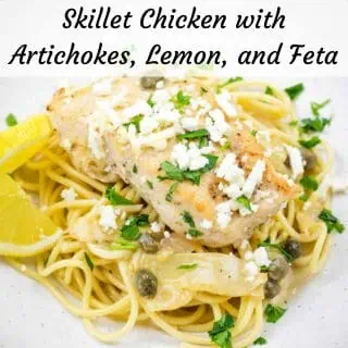 A pasta topped with a Skillet Chicken with Artichokes, Lemon, and Feta on a round plate.