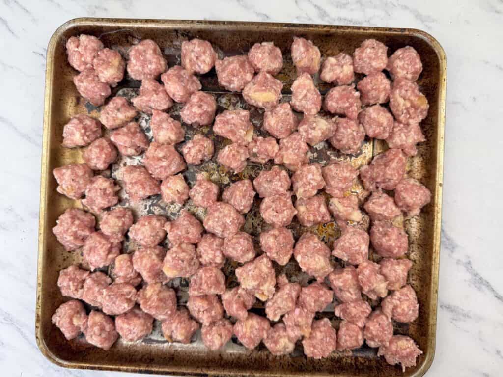Scoop out small portions of the mixture and shape them into meatballs.