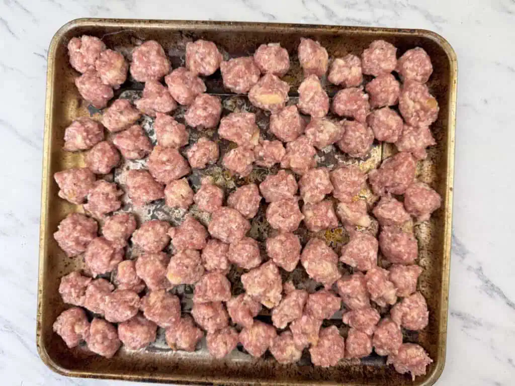 Scoop out small portions of the mixture and shape them into meatballs.