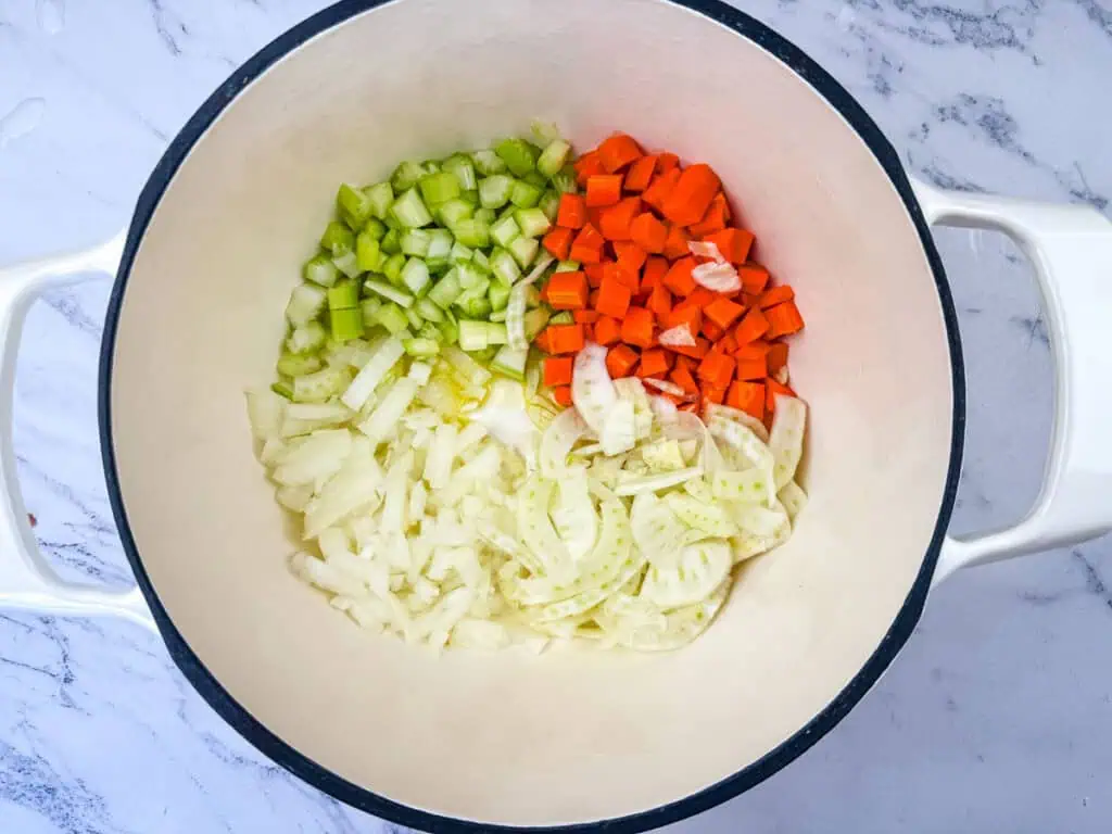 Sautéing the vegetables in cooking pot.