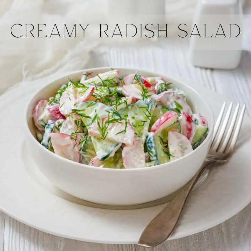 A bowl of creamy radish salad with dill is set on a plate with a fork beside it. Text at the top reads "CREAMY RADISH SALAD.