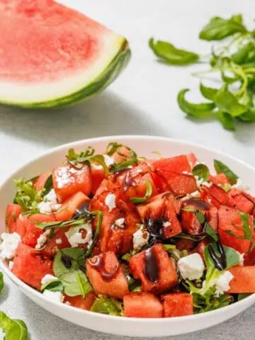 A bowl of Watermelon Salad with Balsamic Glaze and Feta.