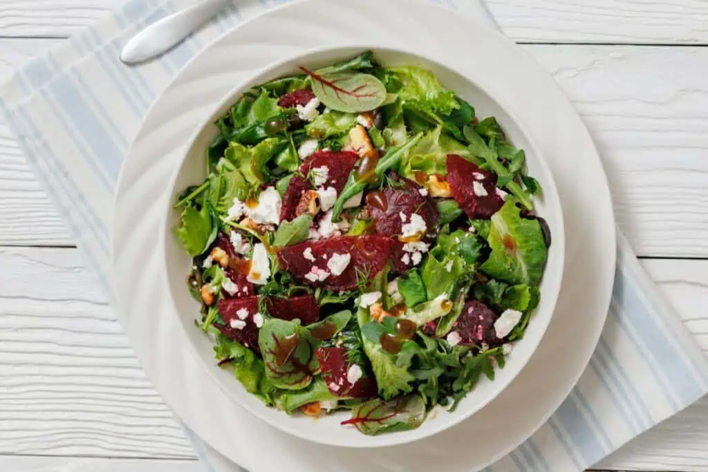 Top-down shot of Beet Salad with Goat Cheese & Walnuts on a bowl.
