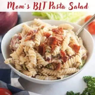 A bowl of BLT pasta salad made with rotini, bacon, lettuce, and tomato, with a fork in the bowl. Text at the top reads "Mom's BLT Pasta Salad.