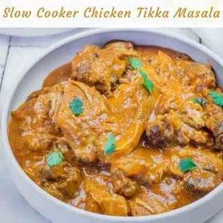 A bowl of rich, orange-colored chicken tikka masala.