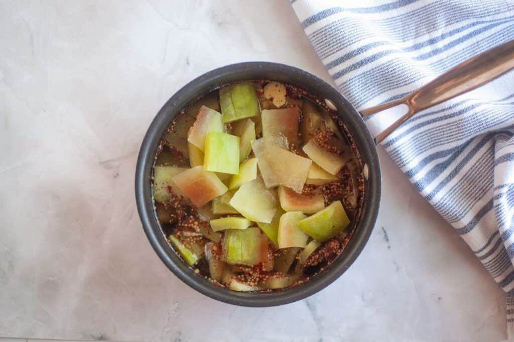 A bowl filled with chopped celery and meat.