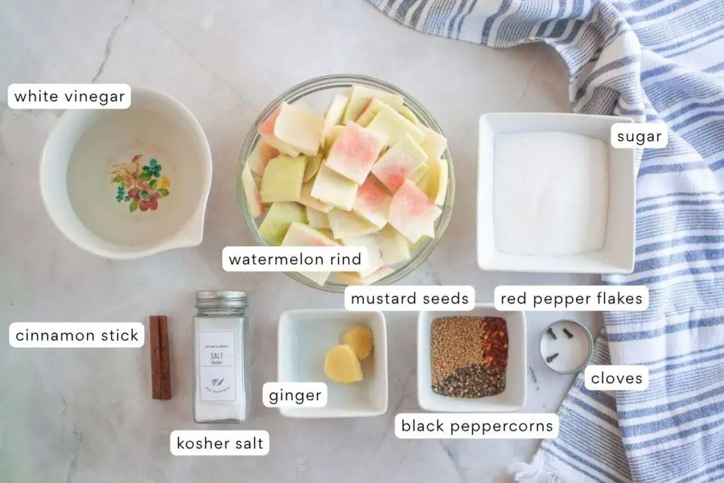 Ingredients for a fruit salad on a marble counter.
