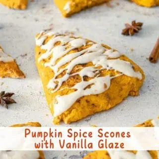 Pumpkin Spice Scones with Vanilla Glaze on a baking sheet.