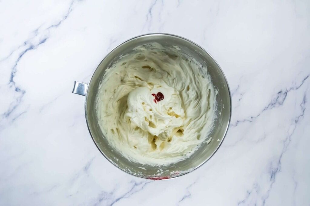 A bowl of whipped cream on a marble counter.