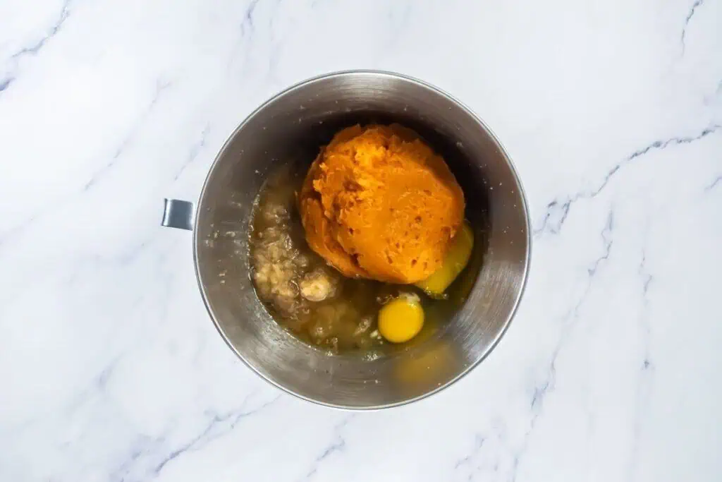 Mixing bowl with pumpkin puree, eggs, and other wet ingredients before combining.