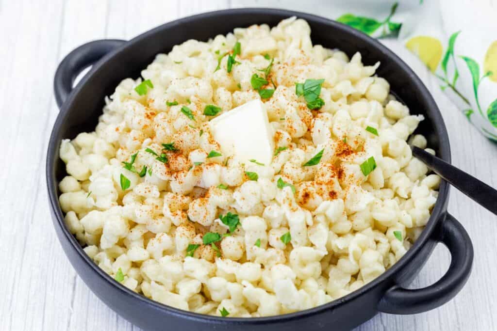 Spaetzle on a black dish.