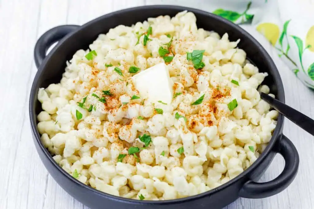 Spaetzle on a black dish.