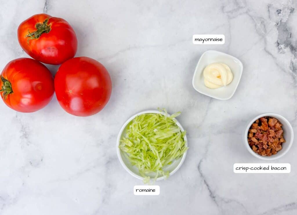 A group of tomatoes and salad ingredients.