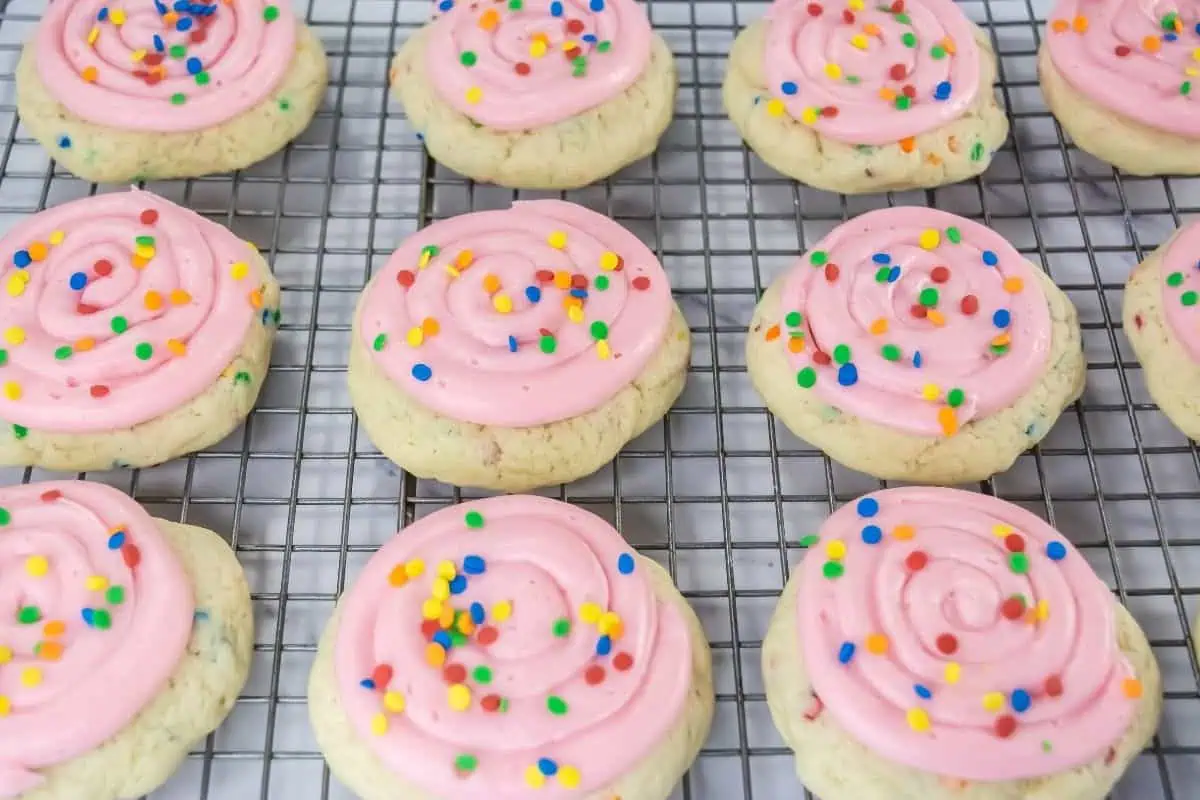 Crumbl Confetti Cake Cookies are arranged on a cooling rack.