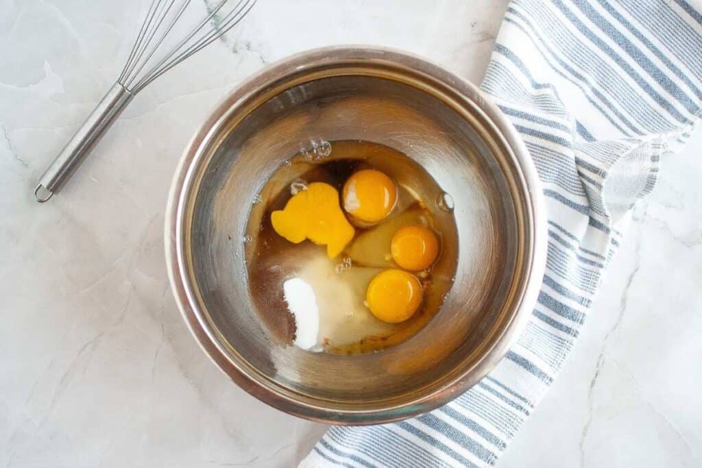 Eggs in a bowl with a whisk.