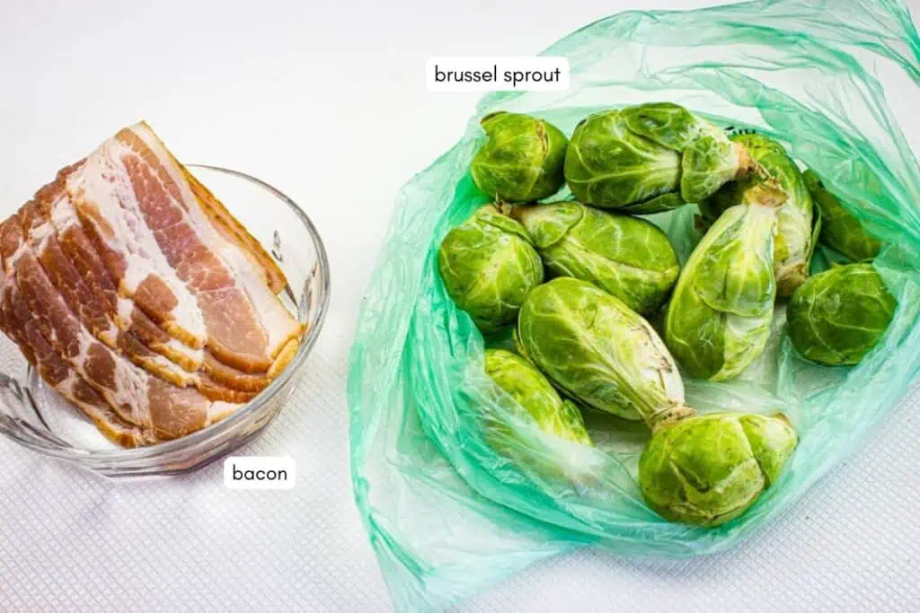 Slices of raw bacon in a glass bowl next to fresh brussels sprouts in a green plastic bag, both labeled.