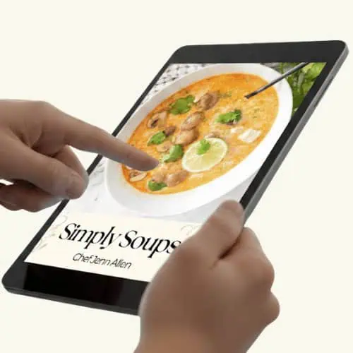 A person holds a tablet displaying a digital cookbook titled "Simply Soups" by Chef Jenn Allen, featuring a soup image on the cover.
