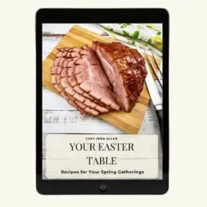 An e-book cover on a tablet displaying a sliced ham on a cutting board with the title "Your Easter Table: Recipes for Your Spring Gatherings" by Chef Jenn Allen.