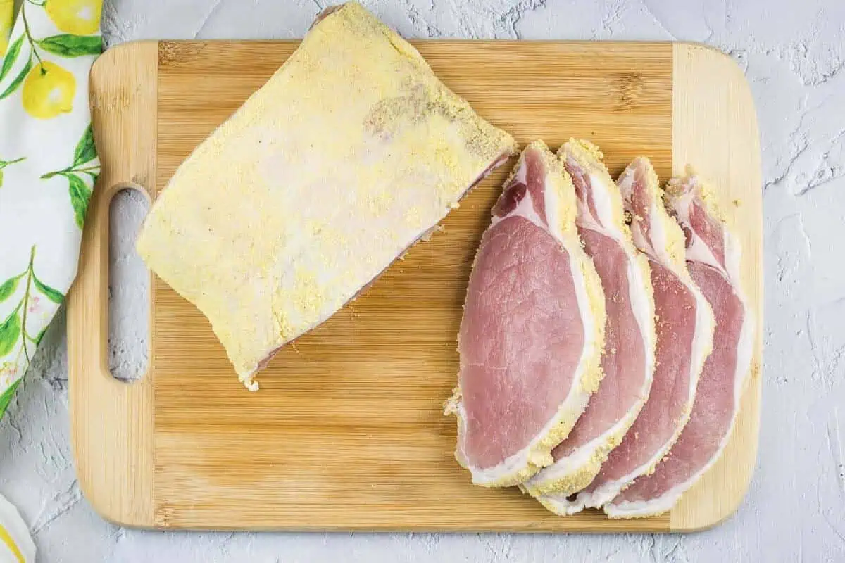 Sliced peameal bacon on a cutting board.